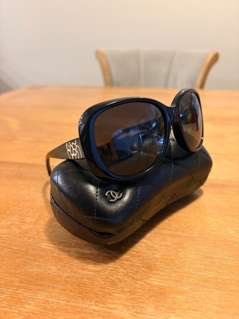 Black authentic Chanel polarized sunglasses with silver logo on the arm